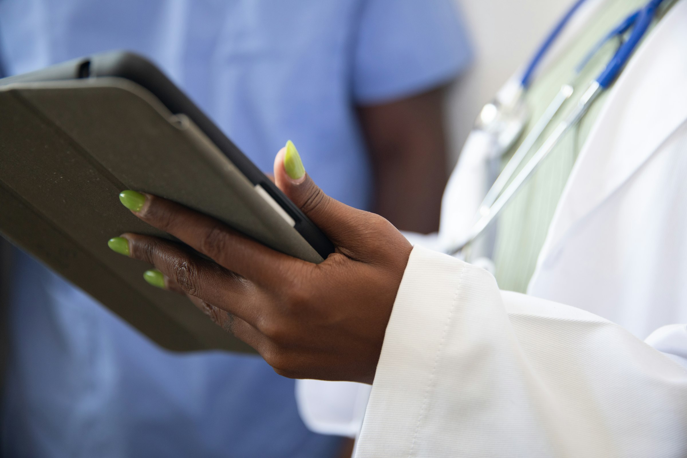 Clinician holding a tablet at the point of care